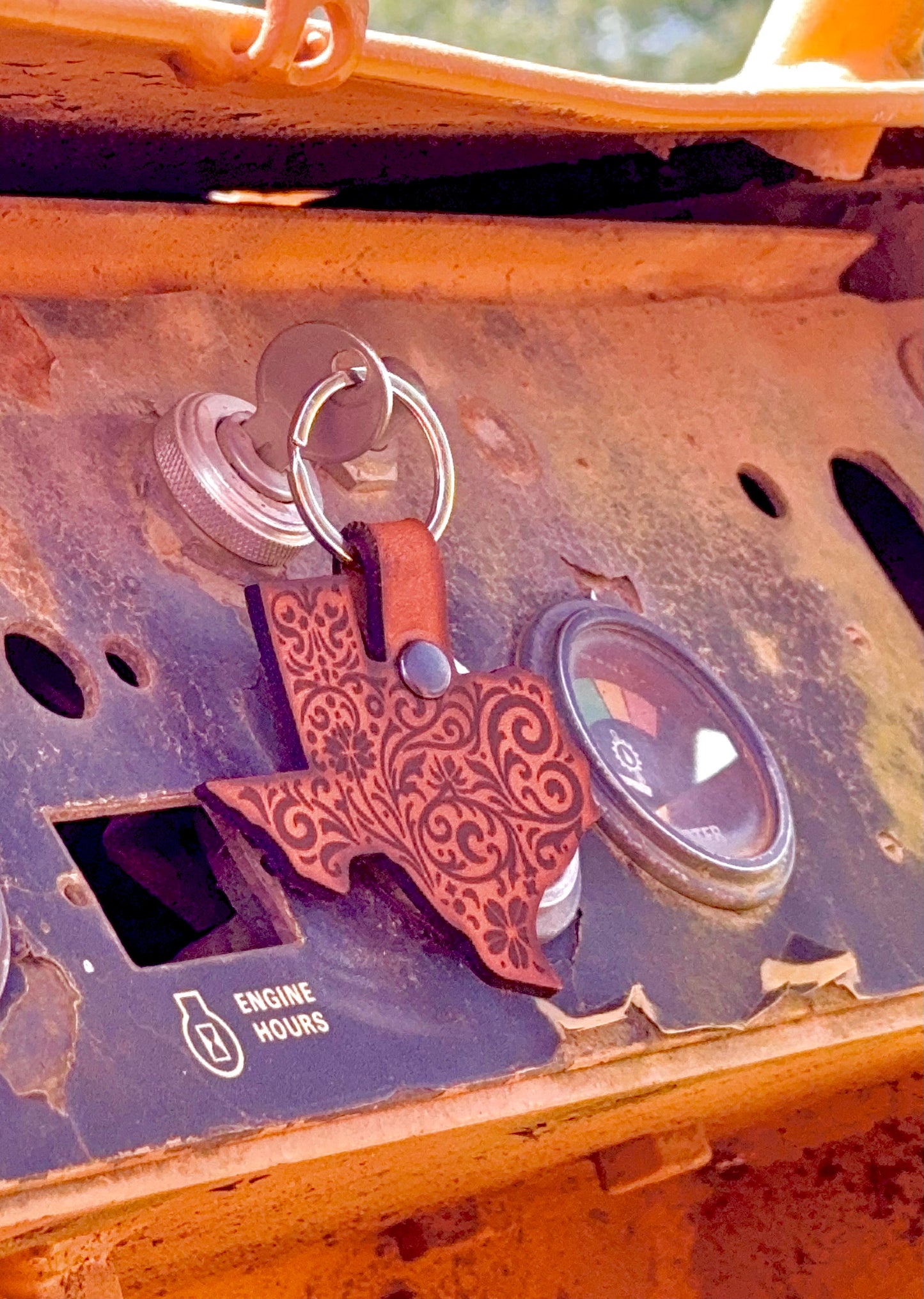 Keychain with a Texas-shaped pendant attached to a vehicle