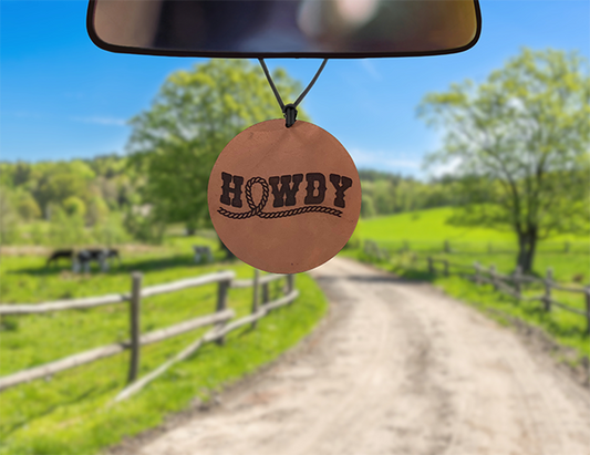 Leather car freshener on dirt road