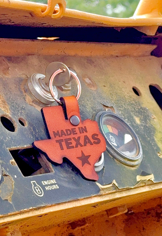 Keychain with 'Made in Texas' design attached to a mechanical surface