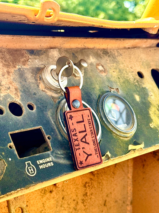 Keychain with 'Texas Y'all' tag attached to a piece of machinery.