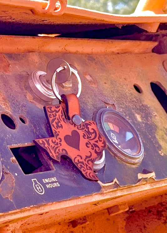 Rust-covered equipment with a decorative keychain featuring a heart design.